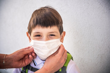 Closeup Kid face wearing protective face mask for pollution or virus, Cropped shot of school boy wearing protection mask against pm 2.5 air pollution.