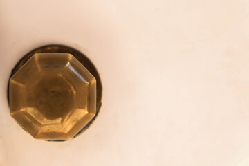 Closeup on a round door handle with decorative elements, door decoration