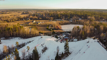 Aerial view of downhill skiing at local ski resort. Ski lift. Russia, Leningrdaskaya oblast, village Korobitsyno near Saint Petersburg.