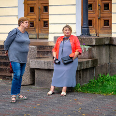 Two nice Mature women relax on the street of the town.