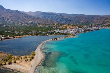 Aerial view showing the causeway connecting Elounda to Kolokitha island along with the remains of the Minoan city of Olous (Crete, Greece)