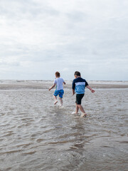 boys paddling at the beach