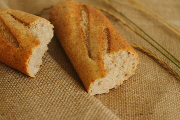 French baguette on sackcloth material, fresh bread on burlap
