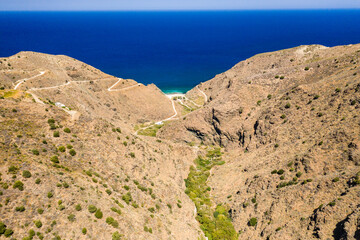 Aerial view of a narrow, barren gorge with lush green foliage in the bottom (Richtis Gorge, Crete, Greece)