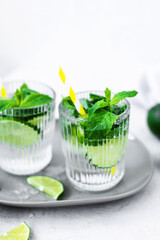 Mojito cocktail with lime, raspberry and mint in a glass. Fresh summer cocktail. Summer mojito