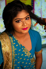 an indian teenage girl taking hair spa at a beauty salon