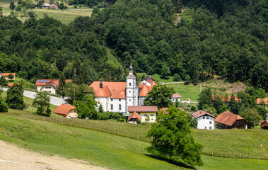 Fototapeta na wymiar Slovenian landscape. Mountain village in Alps with a nice catholic church in Slovenian countryside. 