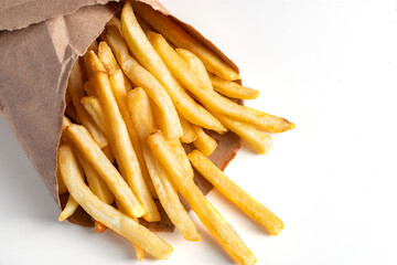 Hot french fries on white background. American unhealthy food