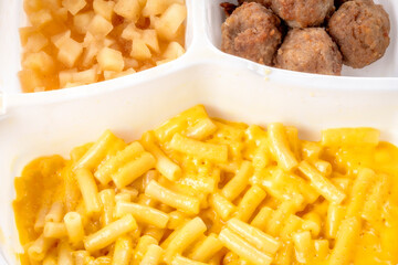 Children’s TV dinner cooked in a white plastic tray
