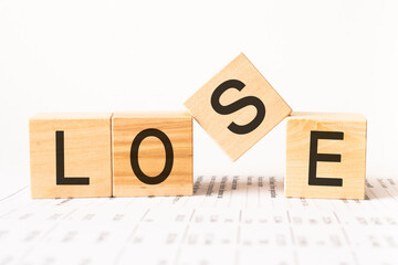 Word lose. Wooden small cubes with letters isolated on white background with copy space available.Business and finance concept