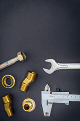 Set of tools and spare parts for plumbing isolated on black background with space for advertising