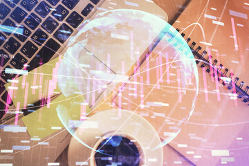 Stock market graph and top view computer on the table background. Double exposure. Concept of financial education.
