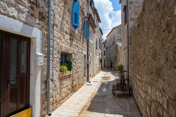 Stari Grad/ Croatia-August 7th, 2020: Narrow dalmatian streets all covered in stone at the oldest town on Hvar island - obrazy, fototapety, plakaty