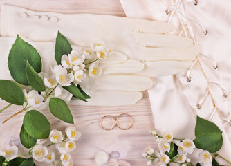 Fototapeta na wymiar Wedding marriage concept.jasmine flowers frame on a wooden table top view.Wedding background with jasmine flowers and bridal accessoies.filtered toned photo flat lay.