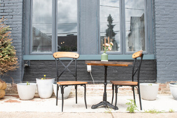 One table and chairs for outside dining in a rustic setting.