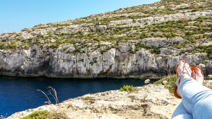 Woman relaxing in Mgarr Ix-Xini, Gozo, Malta