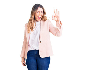 Obraz premium Young caucasian woman wearing business clothes smiling positive doing ok sign with hand and fingers. successful expression.