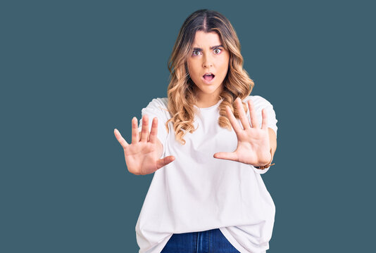 Young caucasian woman wearing casual clothes doing stop gesture with hands palms, angry and frustration expression