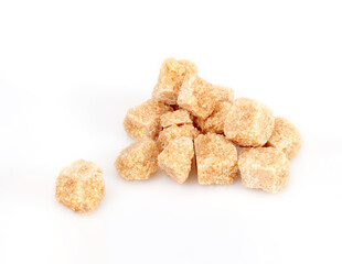Pile of cane sugar cubes isolated on white background
