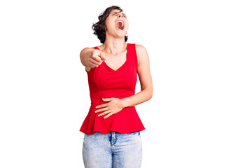 Fototapeta premium Beautiful young woman with short hair wearing casual style with sleeveless shirt laughing at you, pointing finger to the camera with hand over body, shame expression