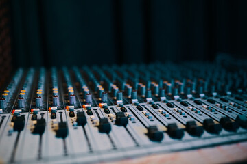 Remote sound engineer. Many buttons of black audio mixer board console for sound producer. Music equipment. Close-up