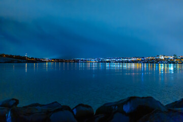 Night photo of Reykjavik city beach. Waterfront lights