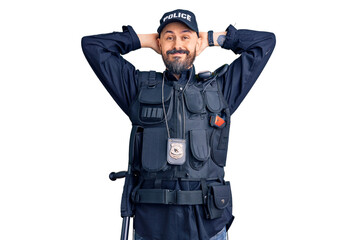 Fototapeta premium Young handsome man wearing police uniform relaxing and stretching, arms and hands behind head and neck smiling happy