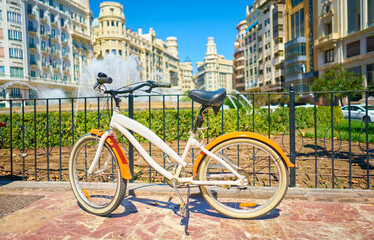 Fototapeta premium Bicycle parked on a city street. Cycling or commuting in the urban environment, ecological transport concept.