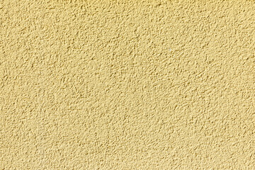 pattern of yellow painted plaster wall