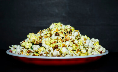 Popcorn in bowl on black background