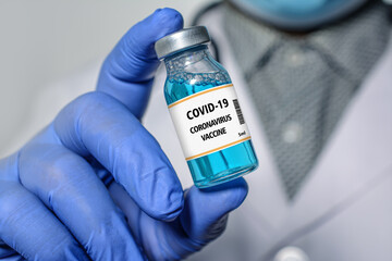 Doctor holds in hand a Coronavirus vaccine that is used for the prevention, immunization and treatment of Coronavirus - Covid-19