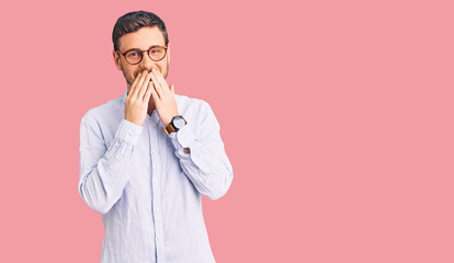 Handsome young man with bear wearing elegant business shirt and glasses laughing and embarrassed...