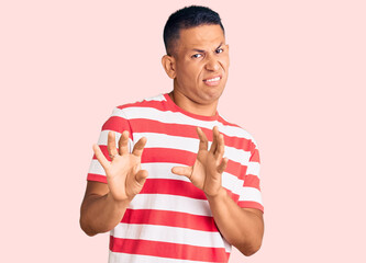 Young handsome latin man wearing casual clothes disgusted expression, displeased and fearful doing...