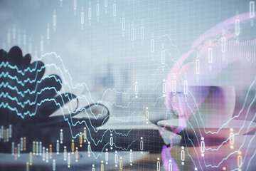 Double exposure of financial chart drawing and desktop with coffee and items on table background. Concept of forex market trading