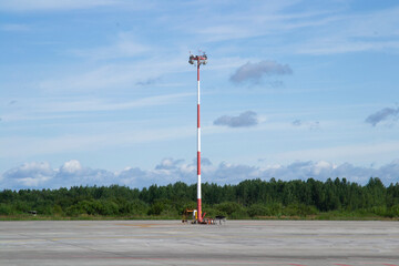 tower with spotlights on the runway. clear sunny day, blue sky background.