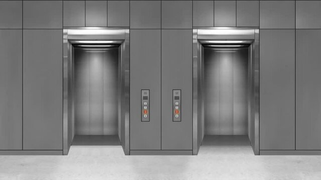 Sliding steel door elevator open showing lift interior. Office building with grey walls.