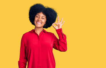 Young african american girl wearing casual clothes smiling positive doing ok sign with hand and fingers. successful expression.