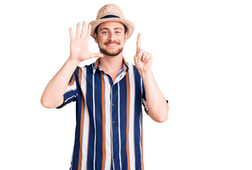 Young handsome caucasian man wearing summer hat showing and pointing up with fingers number six while smiling confident and happy.