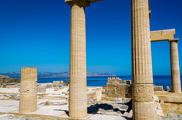 Ruins of Propylaea in the ancient city of Lindos island of Rhodes, Greece. in the Dodecanese archipelago, in the background the Aegean Sea. - 376306722
