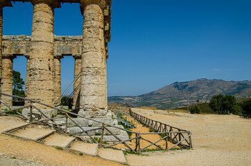 Close-up of the Doric Greek temple of Segesta with the Sicilian countryside in the background, in the Segesta Archaeological Area. Trapani. Sicily. Italy. - 376306776