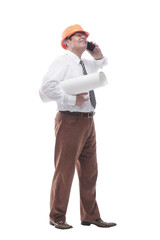 architect in a protective helmet talking on a smartphone. isolated on a white