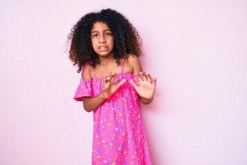 African american child with curly hair wearing casual dress disgusted expression, displeased and...