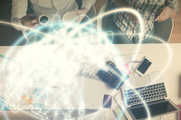 Double exposure of man and woman working together and business theme hologram drawing. Computer background. Top View.