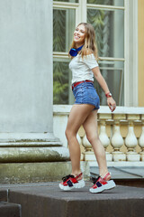 Smiling white woman near historic building.