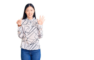 Young beautiful chinese woman wearing casual shirt showing and pointing up with fingers number six while smiling confident and happy.