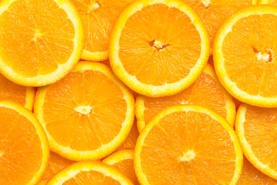 Full frame of fresh orange fruit slices pattern background, close up, high angle view