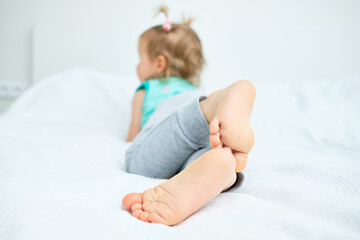Caucasian kid lying on the bed and resting