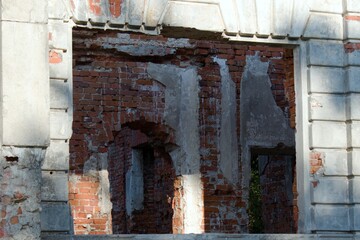 Fototapeta na wymiar outside view through the window of internal brick walls of destroyed palace
