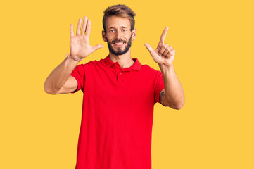 Fototapeta premium Handsome blond man with beard wearing casual clothes showing and pointing up with fingers number seven while smiling confident and happy.