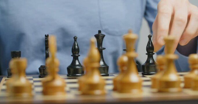 A female hand sets up a chess board in starting position. Close-up, locked down shot.
